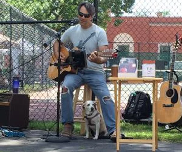 Steve on rooftop deck with guitar case